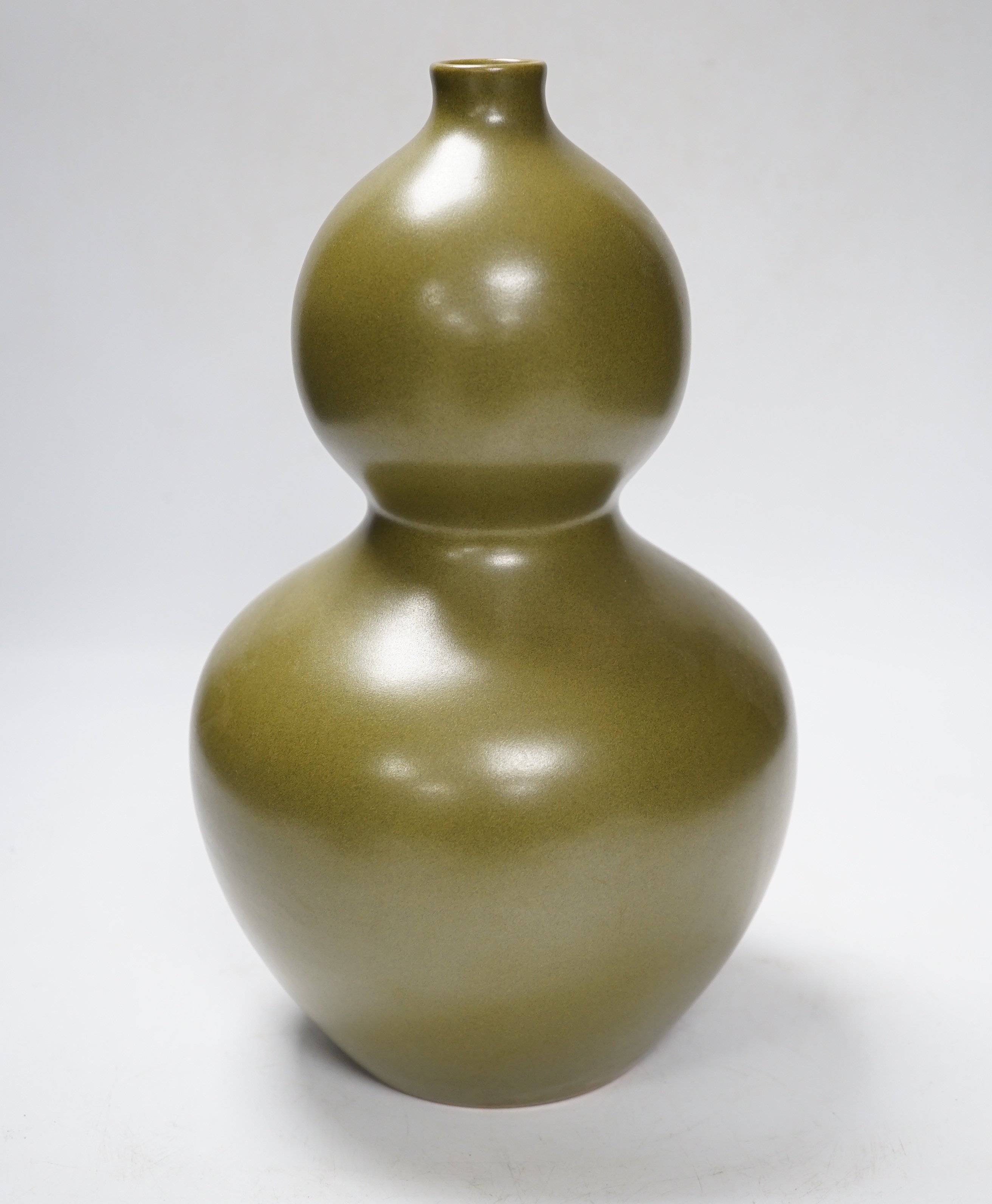 A Chinese olive-green double gourd vase, 29cm high